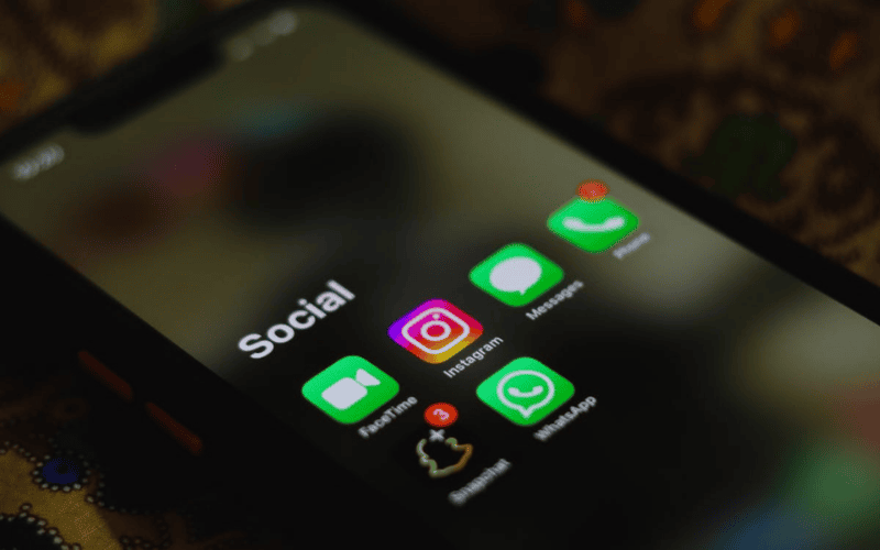 ATT vs TMobile plan comparison for seniors with popular social media apps visible on phone