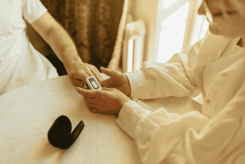 Senior holding a medical alert device while discussing how much is life alert cost at home